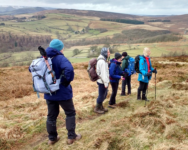 walkers descend moorland