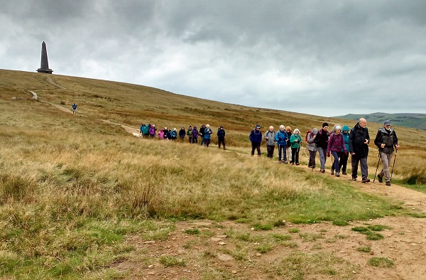 long line of walkers descending from Stoodley Pike